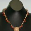 Intricate wood pendant accented with jasper, carnelian, and shell. Chic collection. 18" long. $45